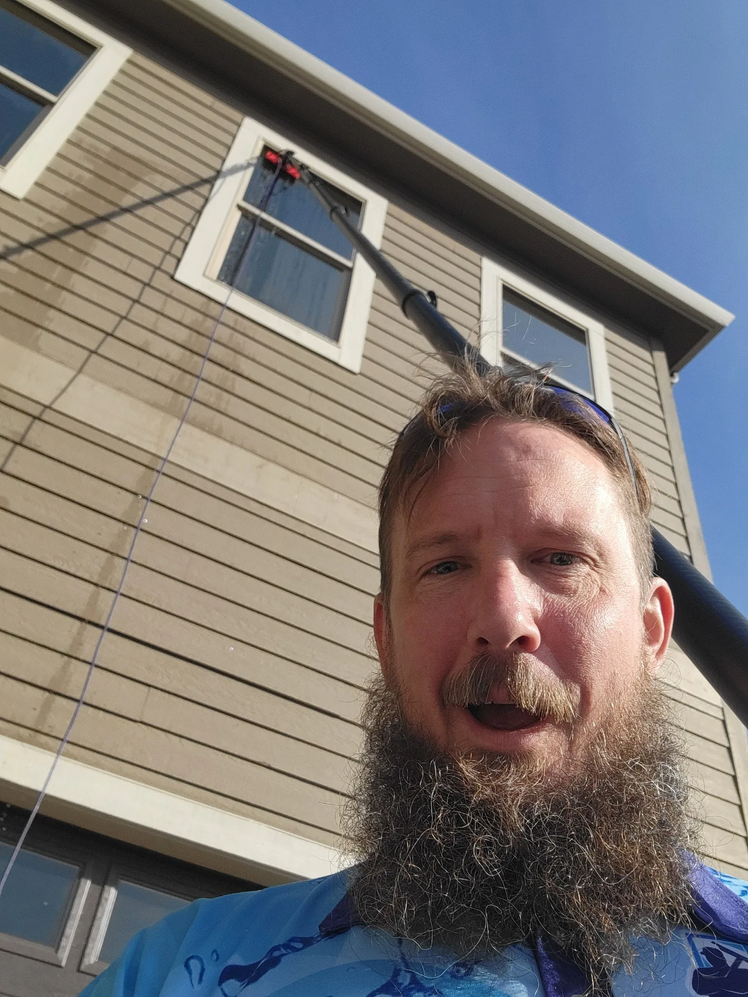 Clearly Window Cleaning owner working on an exterior window cleaning project