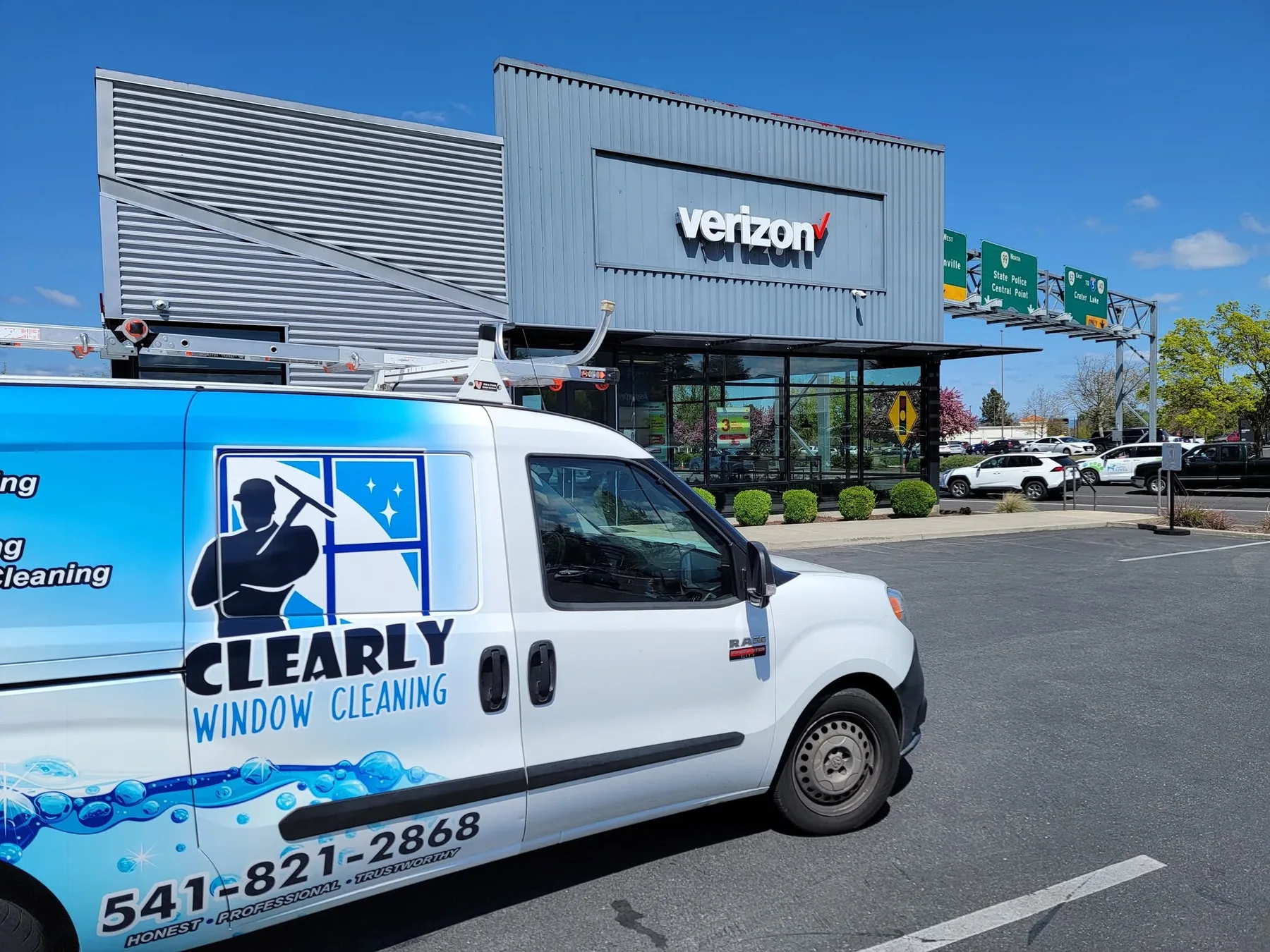 Clearly Window Cleaning commercial work van at a storefront
